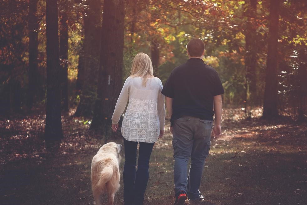 Couple walking dog.